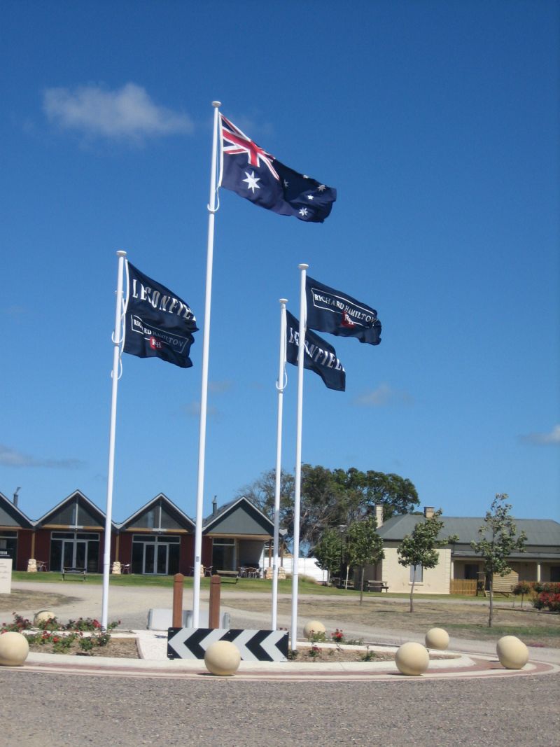 A row of tall poles flying custom printed flags