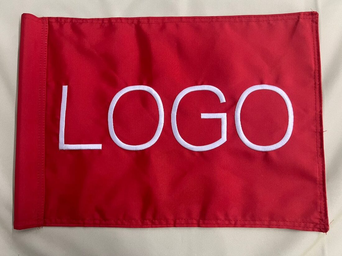 A custom embroidered golf flag sample in red and white